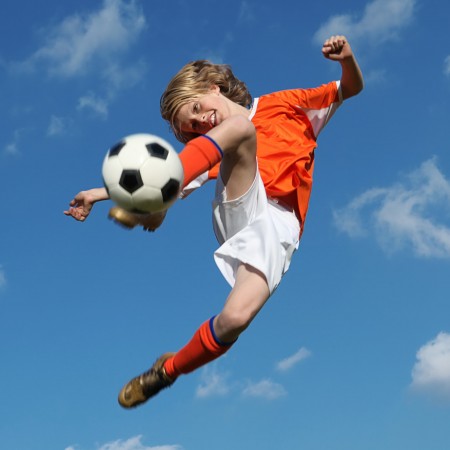 kid-kicking-soccer-in-air